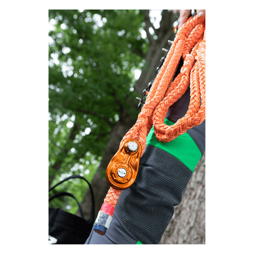 Notch 1/2" Rigging Block in bright orange colour on rope in tree setting